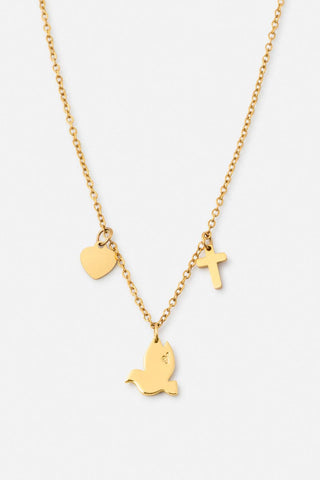Gold necklace with heart, bird, and cross pendants on a white background