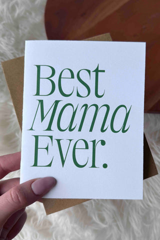 Hand holding a card with 'Best Mama Ever' text on a soft white background