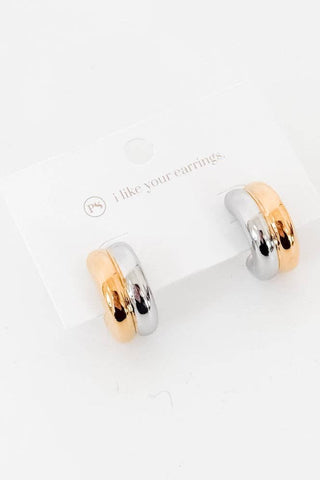 Pair of gold and silver hoop earrings on a white background